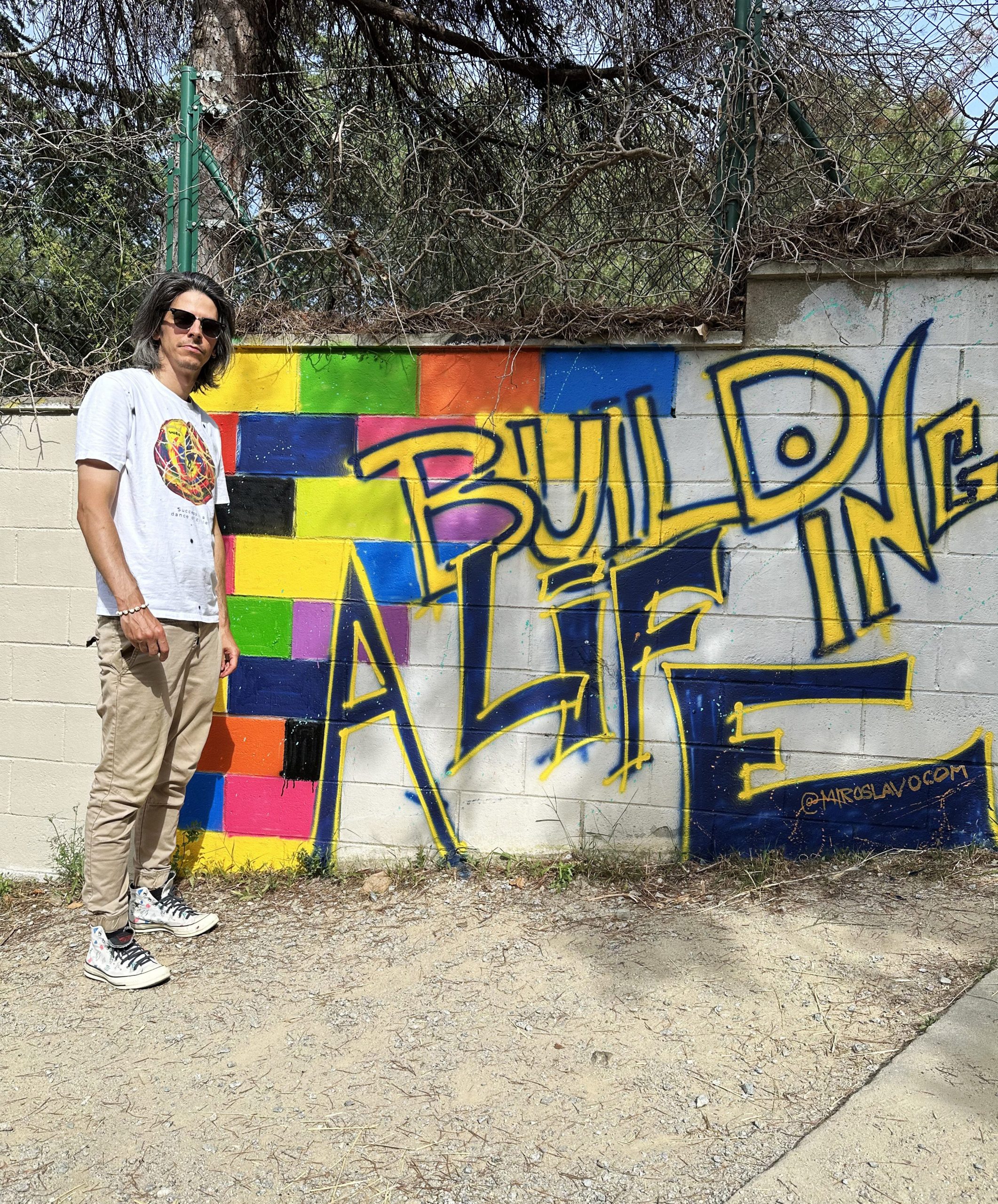 Miroslavo with street mural graffiti in Barcelona.